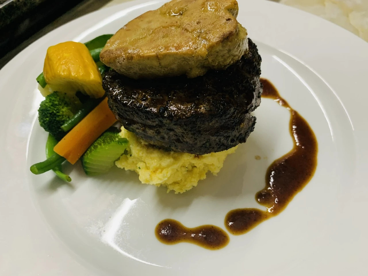 Traditional Tournedos Rossini plating with beef, foie gras and rich sauce